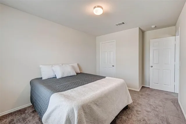 a bedroom with a bed and a night lamp