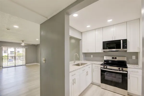a kitchen with a sink stainless steel appliances and cabinets