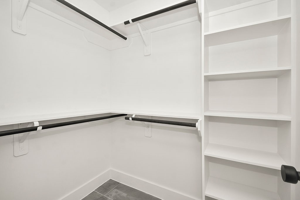 6106 Rutherglenn Drive Houston, TX 77096 - Photo 27 of 41 Custom walk-in closet with built-in shelving and exceptional organization space.