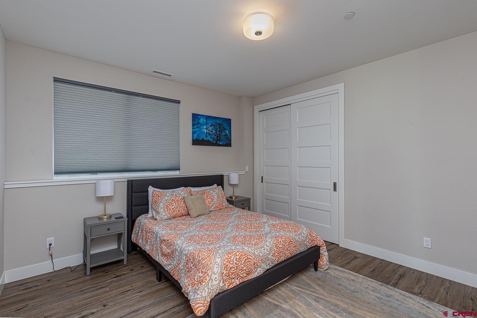 107 Tacoma Drive Durango, CO 81301 - Photo 17 of 29 a bedroom with a bed and wooden floor