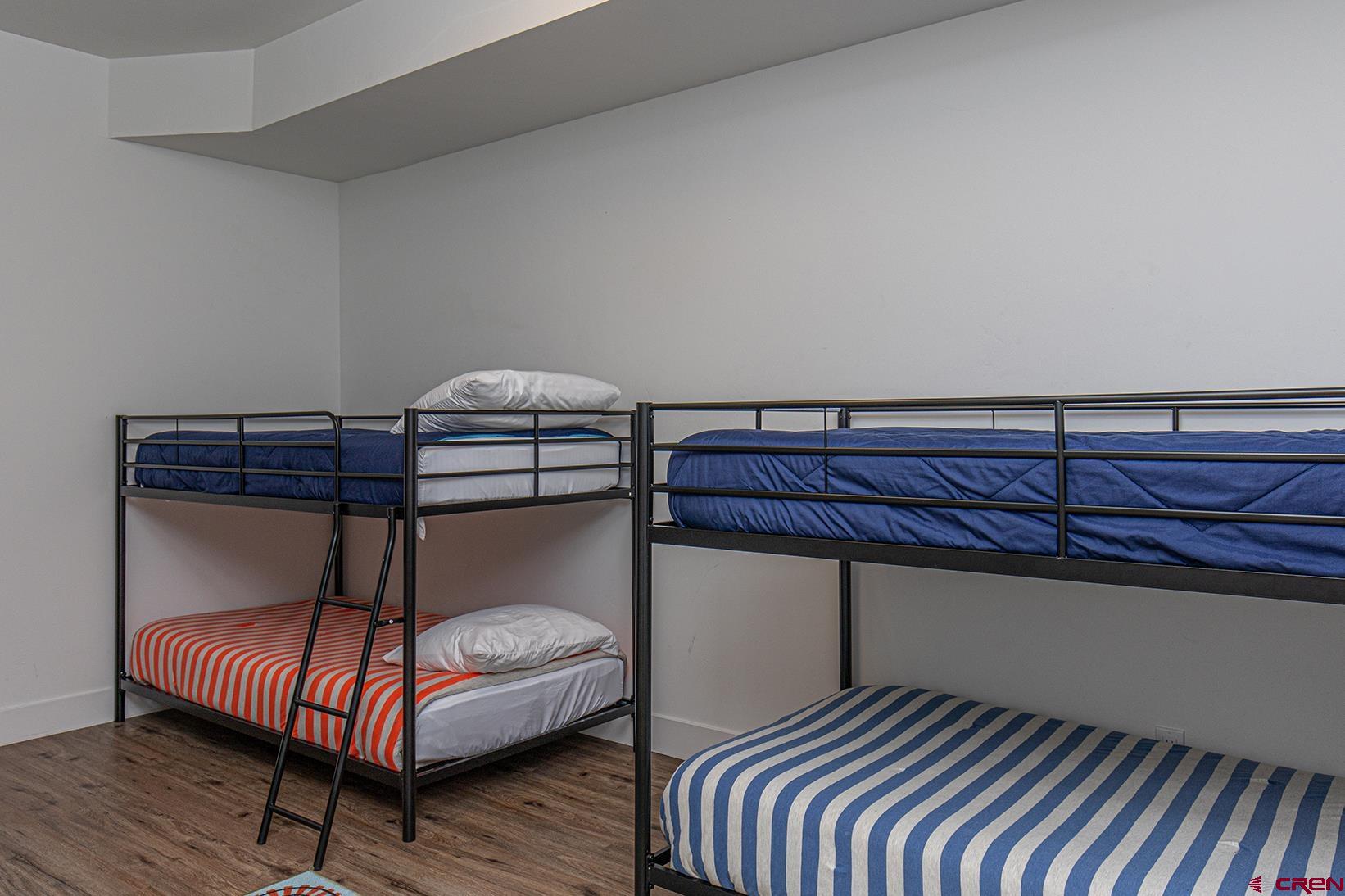 107 Tacoma Drive Durango, CO 81301 - Photo 19 of 29 a bedroom with a bed window and wooden floor