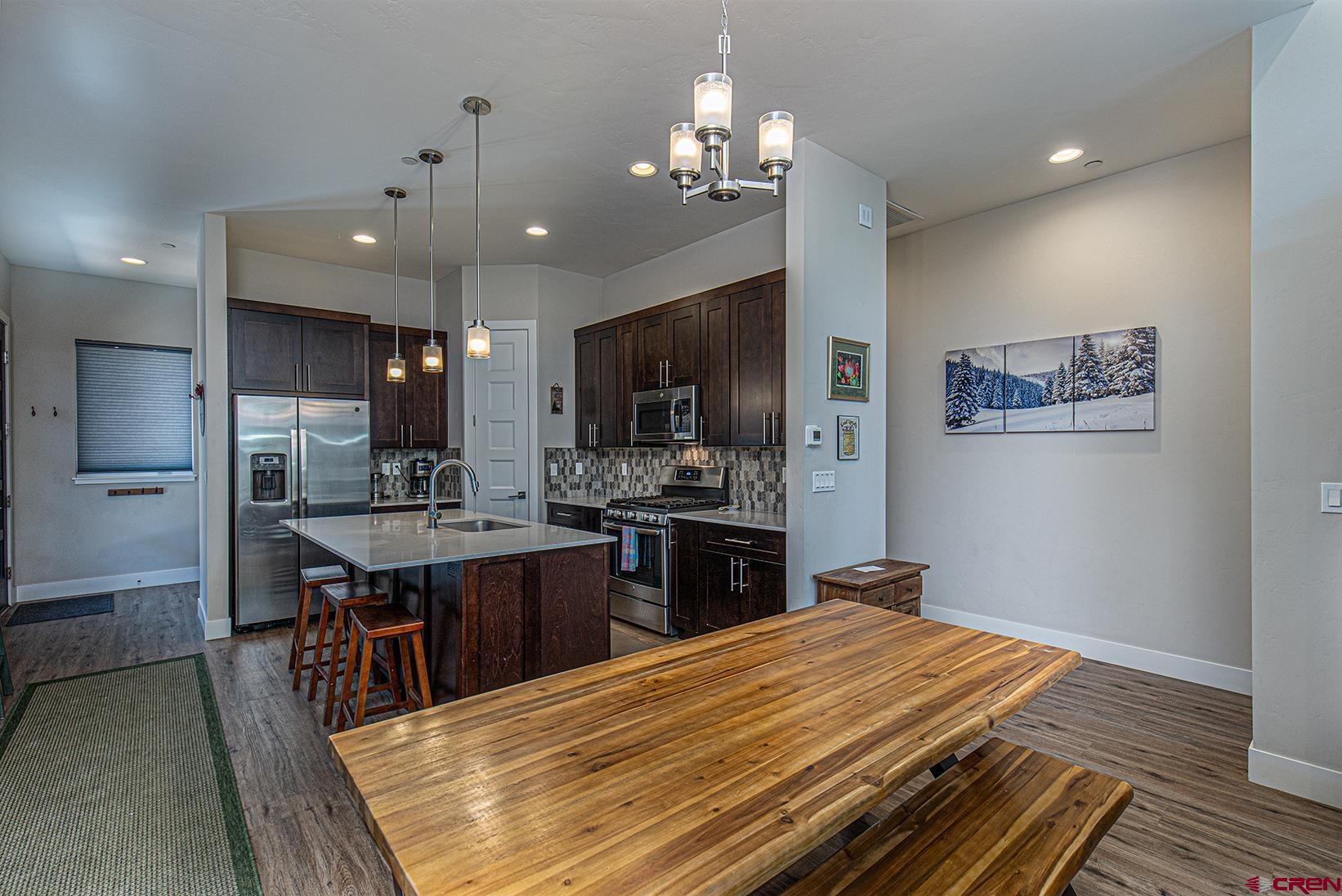 107 Tacoma Drive Durango, CO 81301 - Photo 4 of 29 a kitchen with stainless steel appliances kitchen island granite countertop a sink dishwasher stove and refrigerator