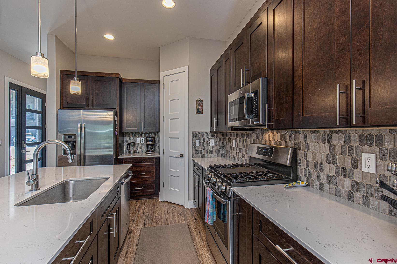 107 Tacoma Drive Durango, CO 81301 - Photo 5 of 29 a kitchen with stainless steel appliances a sink stove microwave and refrigerator