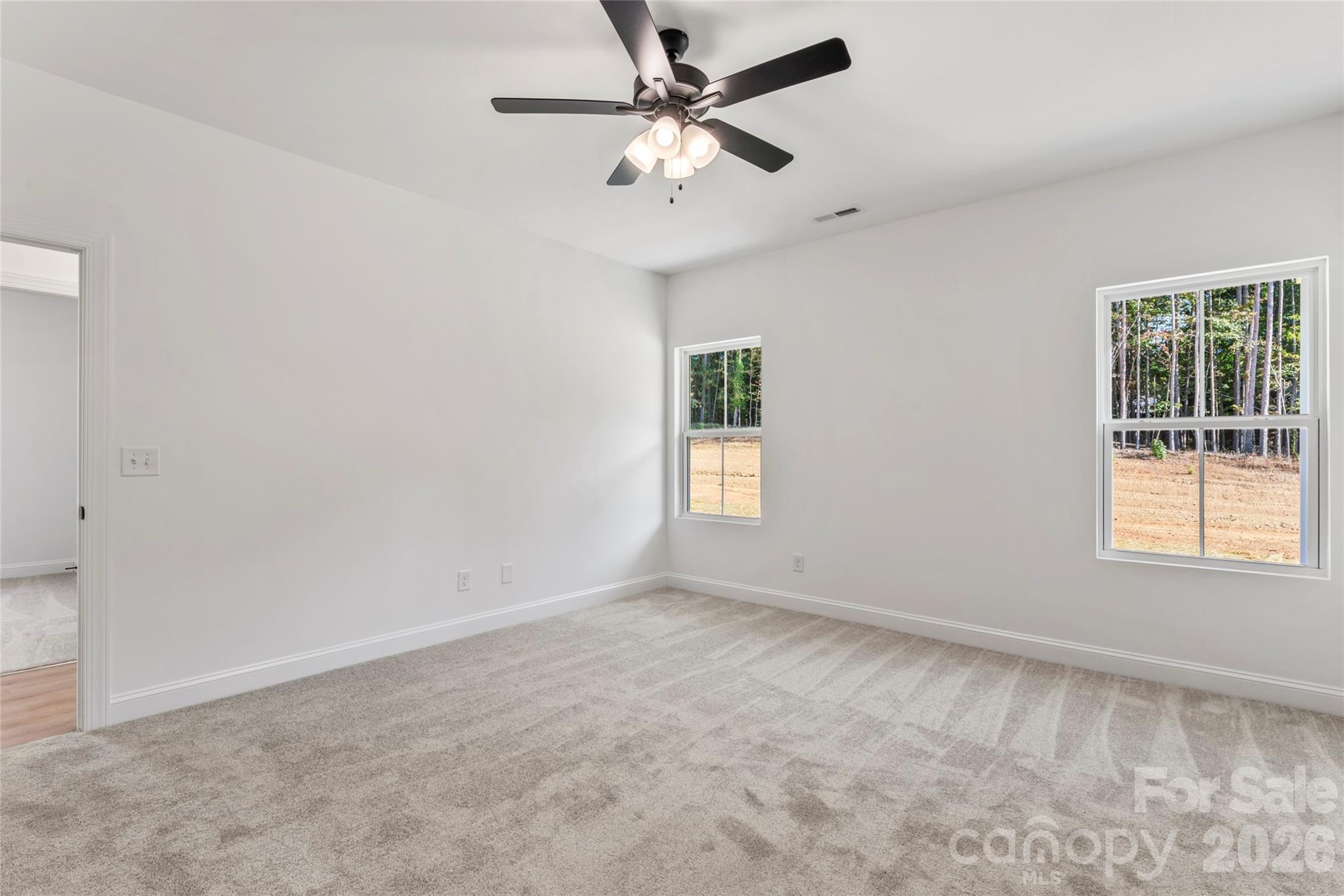 755 Mockingbird Road, Unit 3 Albemarle, NC 28001 - Photo 17 of 25 an empty room with a window and a fan