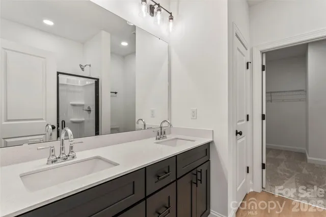 a bathroom with a sink double vanity and a mirror