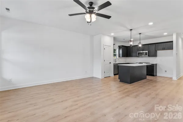 a kitchen with stainless steel appliances a refrigerator sink and microwave
