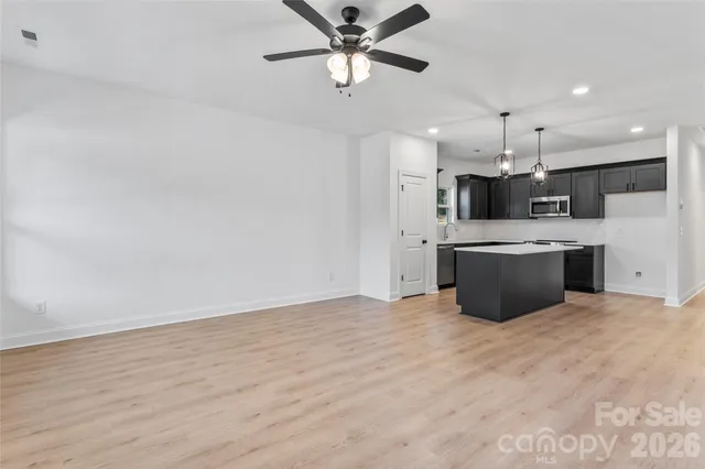 a kitchen with stainless steel appliances a refrigerator sink and microwave