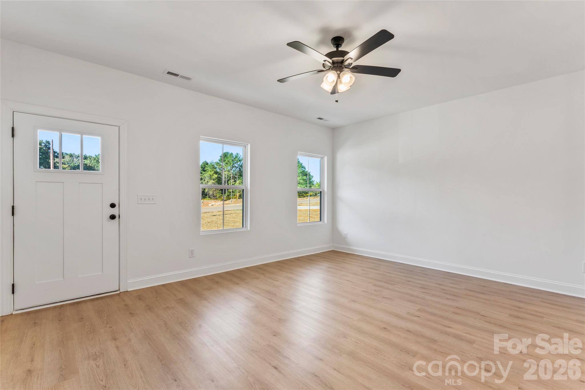 755 Mockingbird Road, Unit 3 Albemarle, NC 28001 - Photo 9 of 25 wooden floor in an empty room with a window