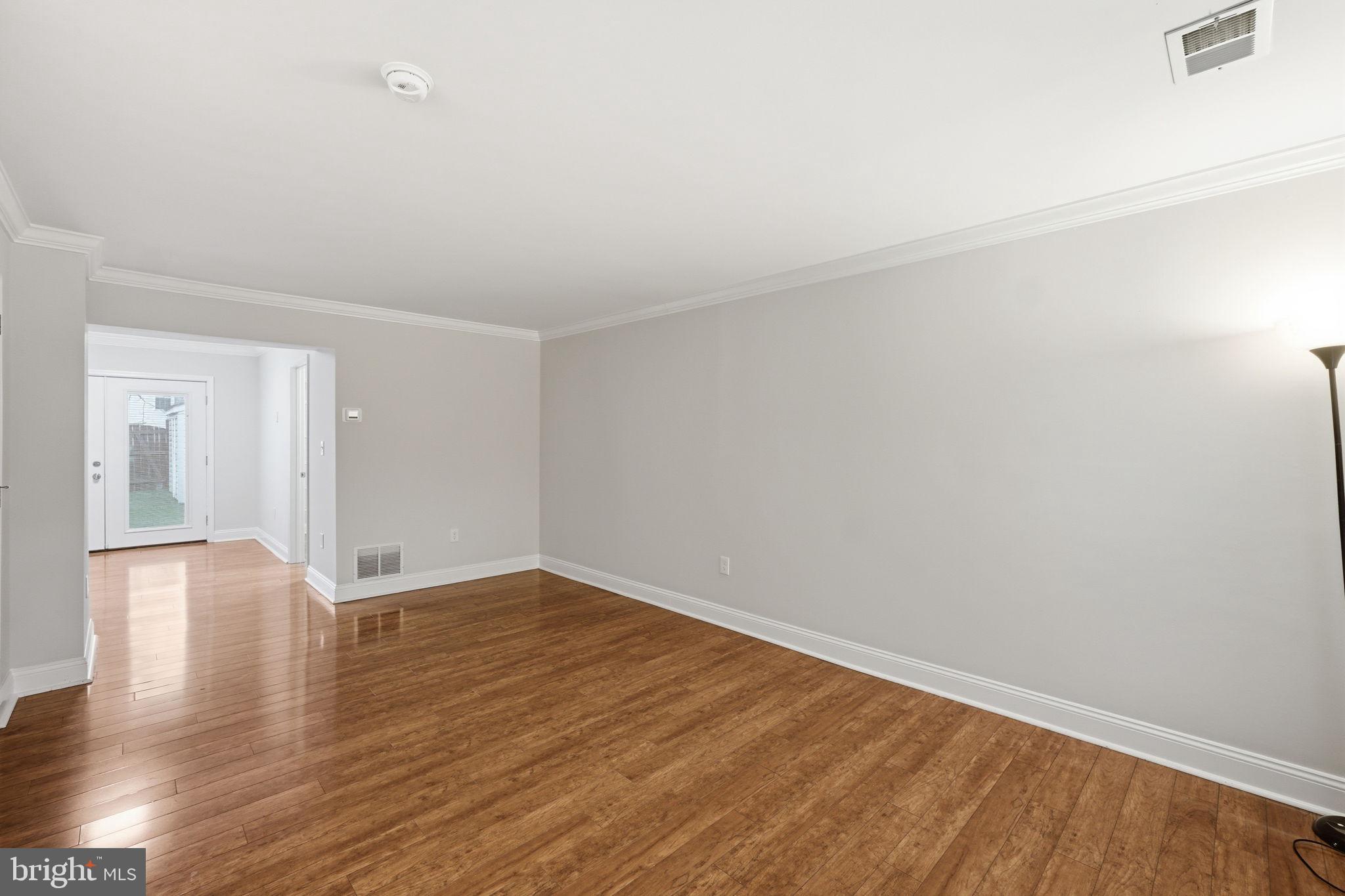 524 Lancaster Place, Unit 524 Frederick, MD 21703 - Photo 11 of 28 a view of an empty room and wooden floor