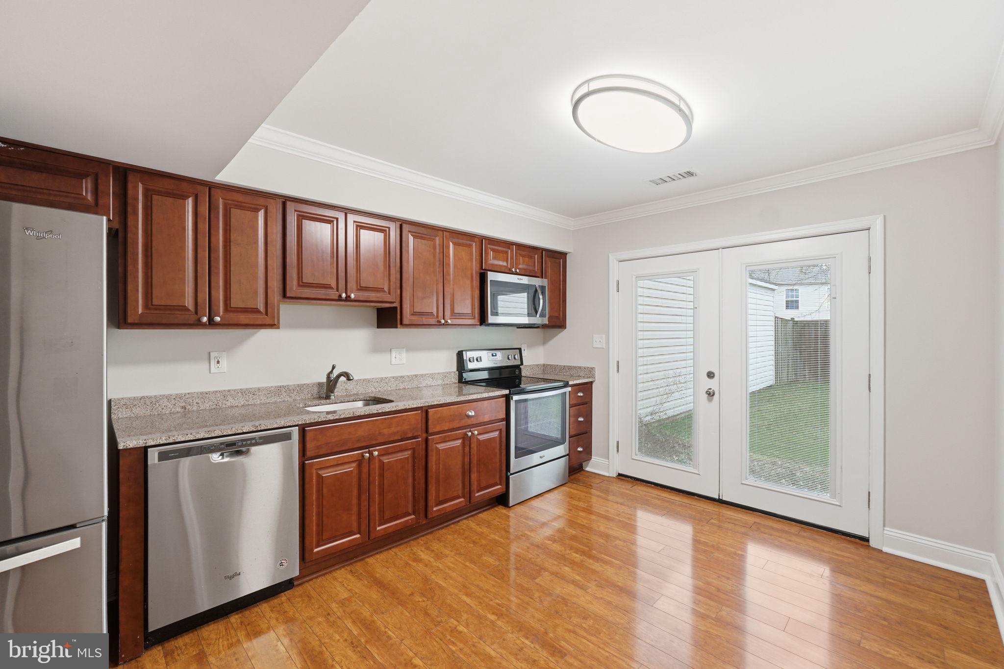 524 Lancaster Place, Unit 524 Frederick, MD 21703 - Photo 6 of 28 a kitchen with stainless steel appliances granite countertop a stove a sink dishwasher and a refrigerator