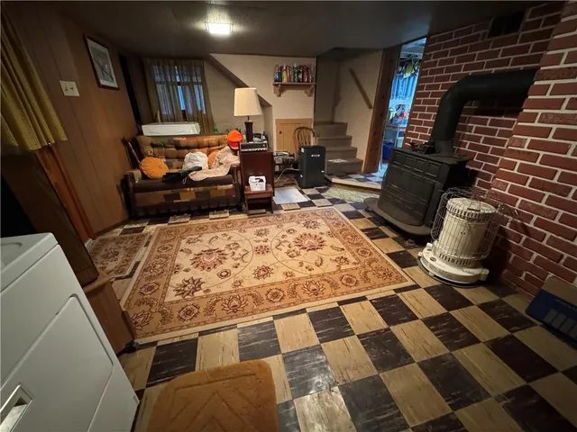 a picture of water heater room with wooden floor