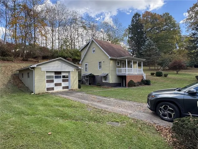 a front view of a house with a garden and yard