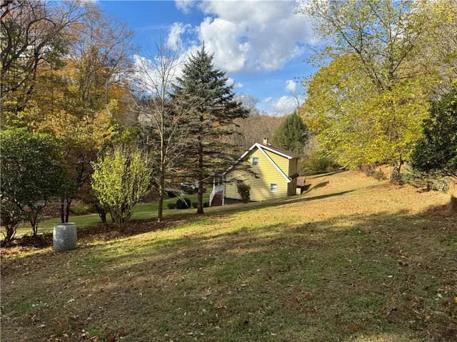 a view of a yard with large trees