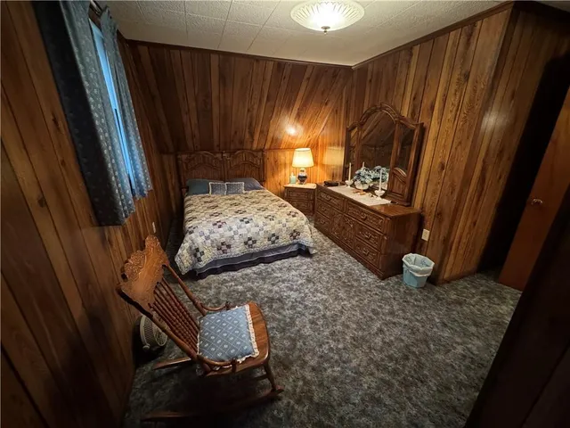 a view of a hallway with wooden floor and stairs