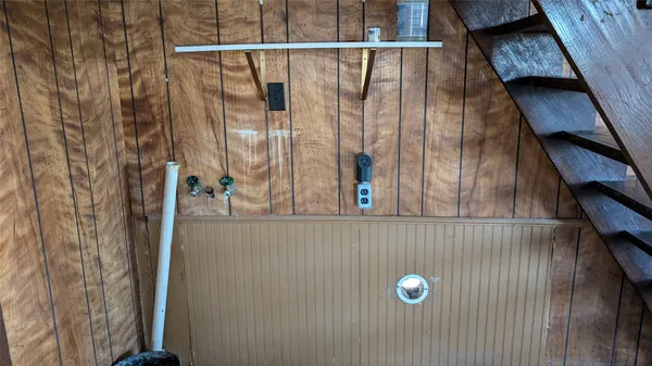 a room with wooden floor and windows