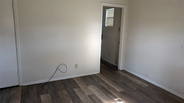 a view of an empty room with wooden walls