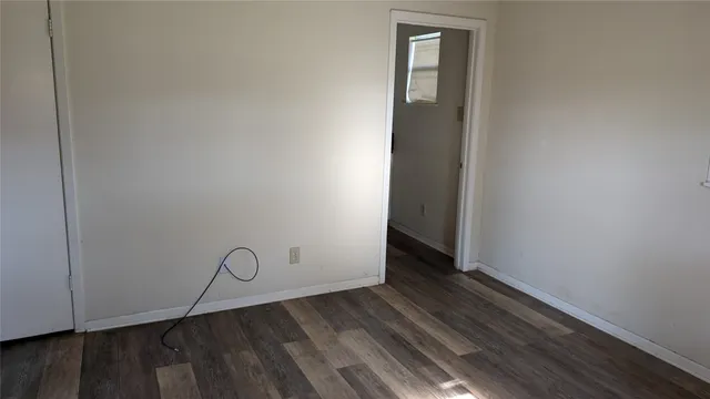 a view of an empty room with wooden walls