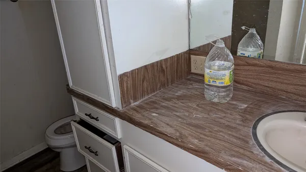 a view of a field with trees in background