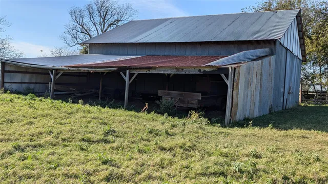 a view of a field with trees in background