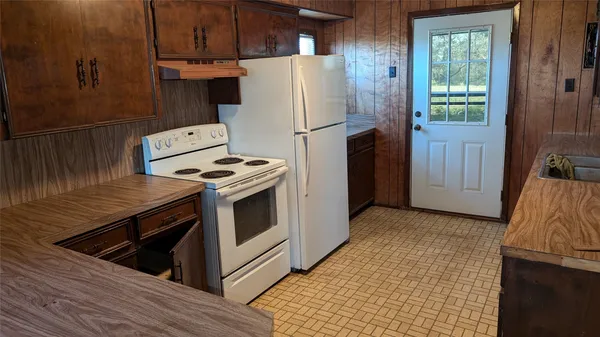 a kitchen with a stove and a refrigerator
