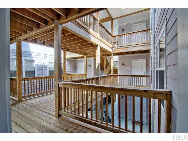 929 Morreene Road, Unit A24 Durham, NC 27705 - Photo 3 of 13 a view of a balcony with wooden floor