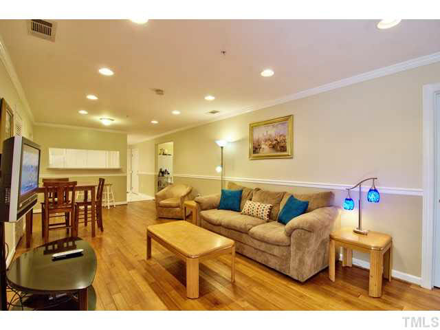 929 Morreene Road, Unit A24 Durham, NC 27705 - Photo 4 of 13 a living room with furniture and a flat screen tv