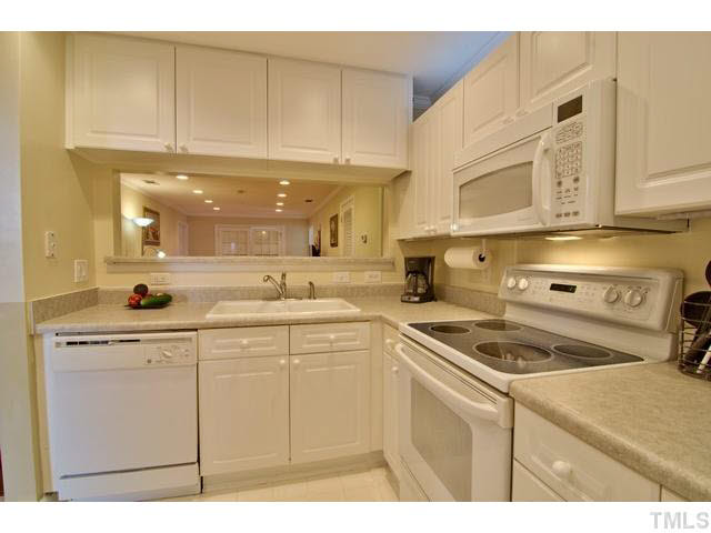 929 Morreene Road, Unit A24 Durham, NC 27705 - Photo 7 of 13 a kitchen with stainless steel appliances granite countertop a sink a stove and cabinets