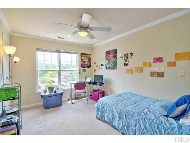 929 Morreene Road, Unit A24 Durham, NC 27705 - Photo 10 of 13 a bedroom with a bed and a chandelier
