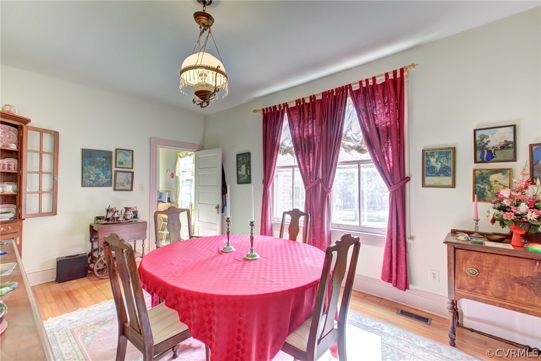 3048 River Road West Goochland, VA 23063 - Photo 13 of 49 a dining room with furniture a chandelier and window