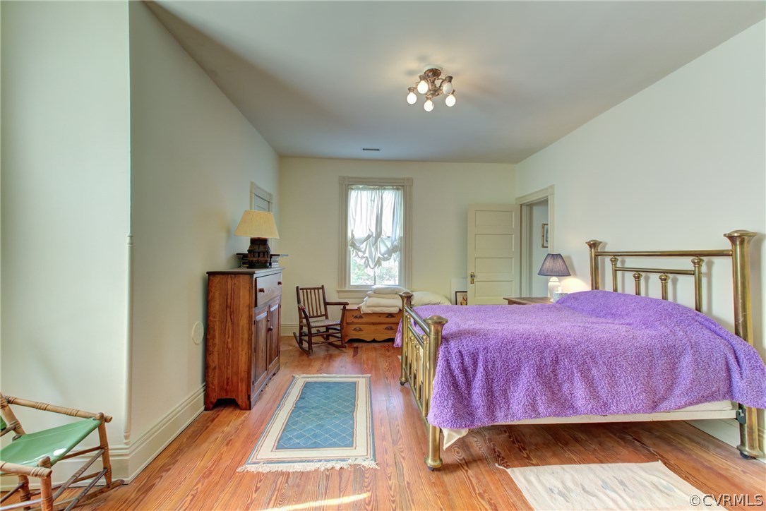 3048 River Road West Goochland, VA 23063 - Photo 27 of 49 a bedroom with a bed and wooden floor