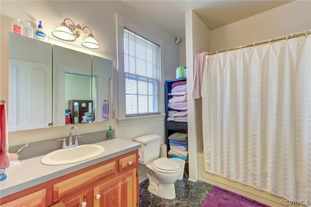 3048 River Road West Goochland, VA 23063 - Photo 31 of 49 a bathroom with a sink a toilet and a mirror