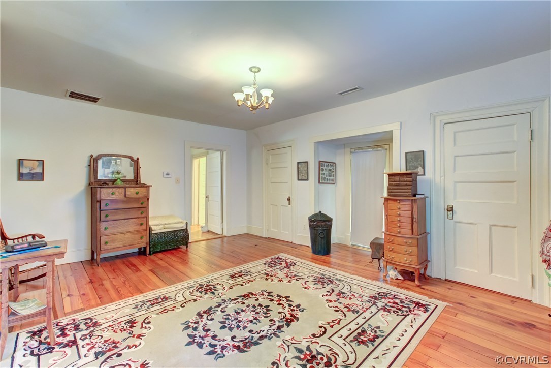 3048 River Road West Goochland, VA 23063 - Photo 33 of 49 a living room with a bed and a dresser next to a window