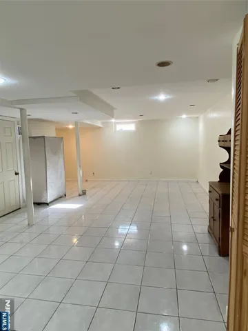 a view of a livingroom with an empty space and a window