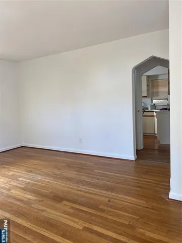 a view of a room with wooden floor and chair