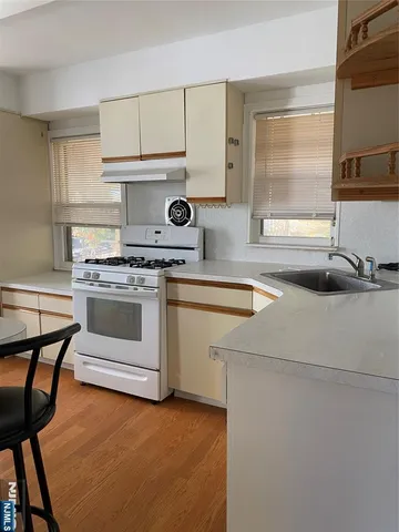 a kitchen with a stove a sink and a cabinets