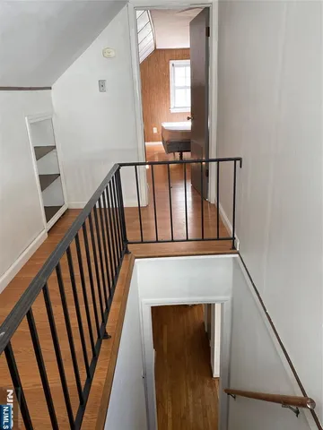 a view of staircase with railing and a window