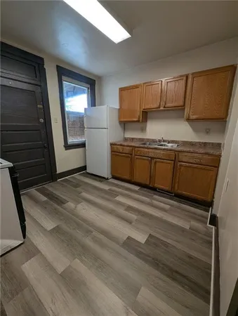a kitchen with stainless steel appliances granite countertop a stove a sink and a refrigerator
