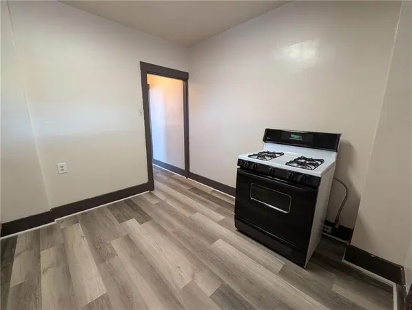 a view of kitchen and an empty room