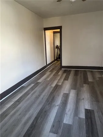 a view of an empty room and wooden floor