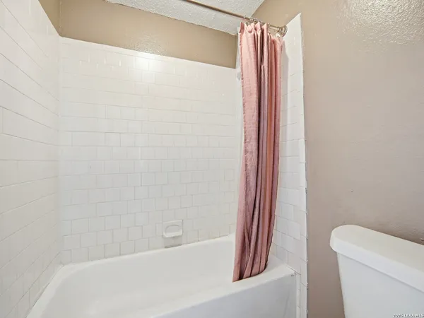 a bathroom with a shower and a toilet