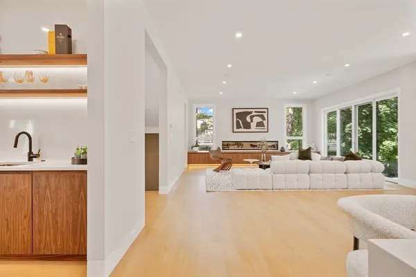 a large white room with a large window and a couch