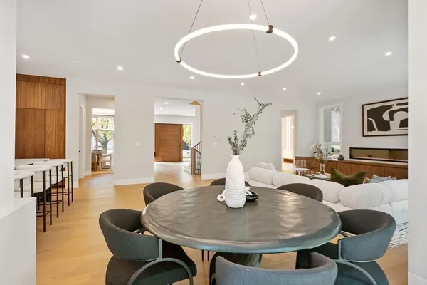 a dining room with furniture a window and wooden floor