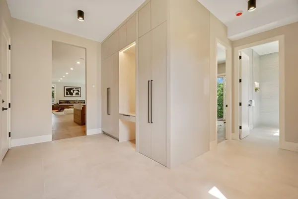 a view of a kitchen with a refrigerator and a sink
