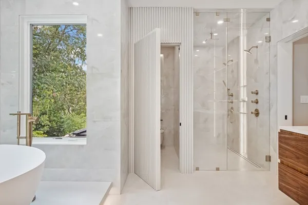 a bathroom with a shower and a tub