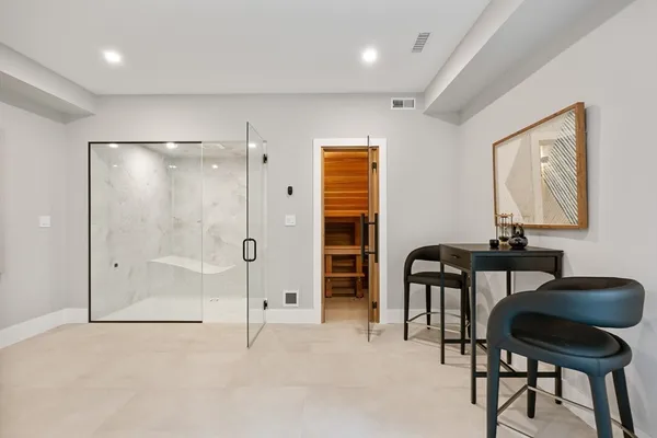 a bathroom with a sink mirror and a shower