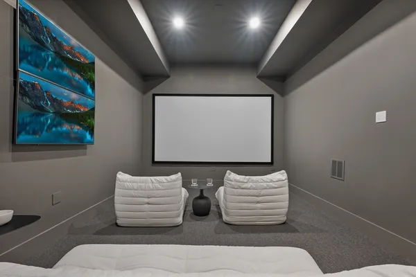 a room with two couches and painting on the wall