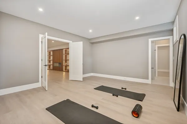 a room with gym equipment and view of living room