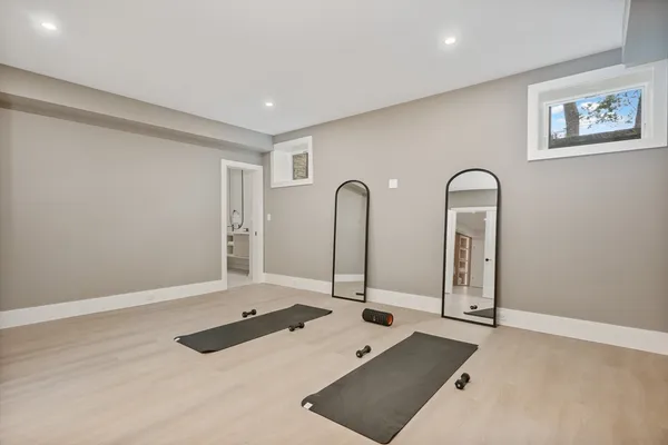a view of a room with two mirror and window