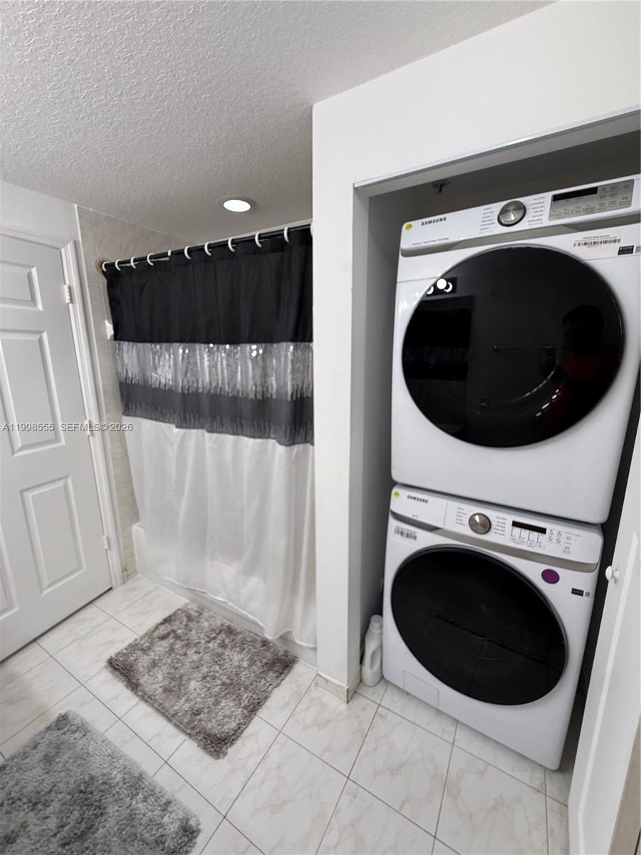 119 Southwest 6th Avenue, Unit 405 Miami, FL 33130 - Photo 12 of 23 a view of a hallway with washer and dryer