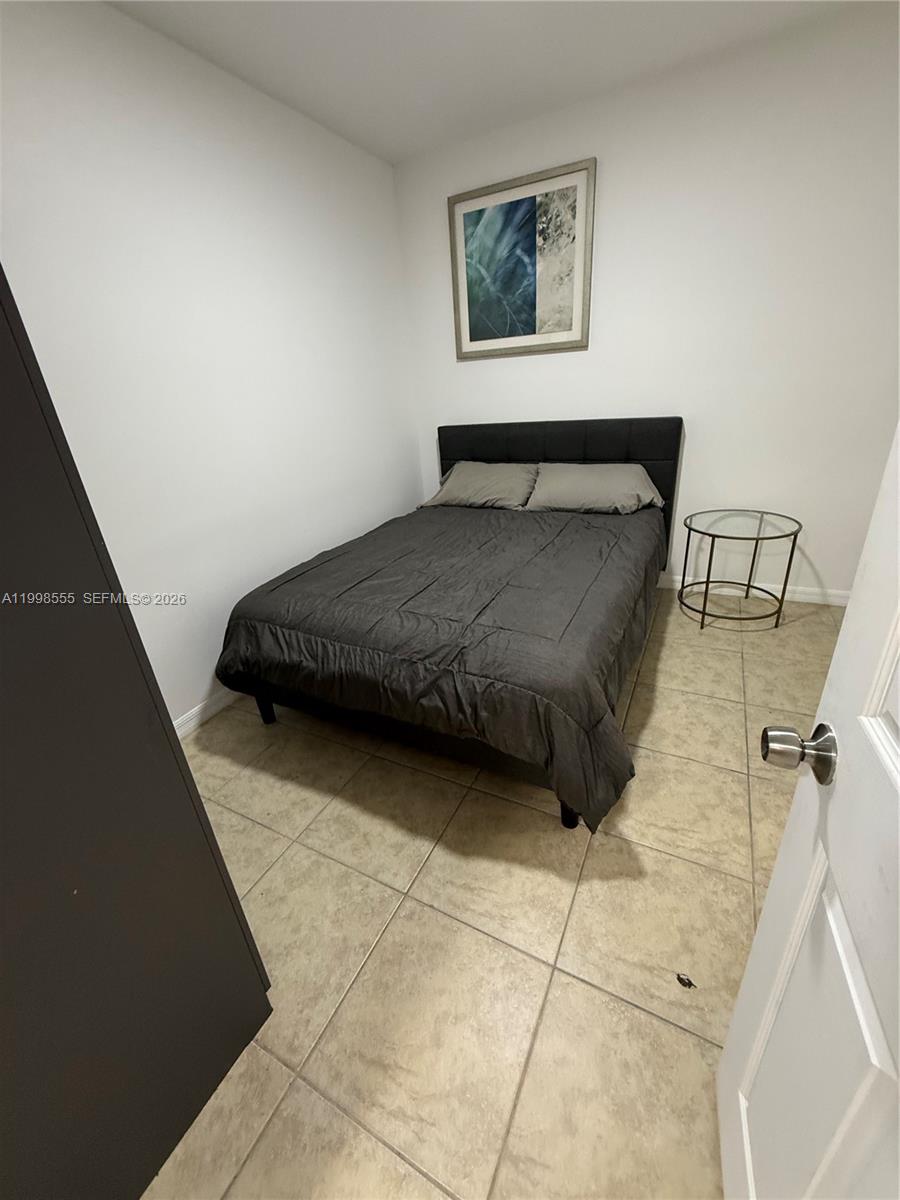 119 Southwest 6th Avenue, Unit 405 Miami, FL 33130 - Photo 14 of 23 a bedroom with a bed and a cabinets